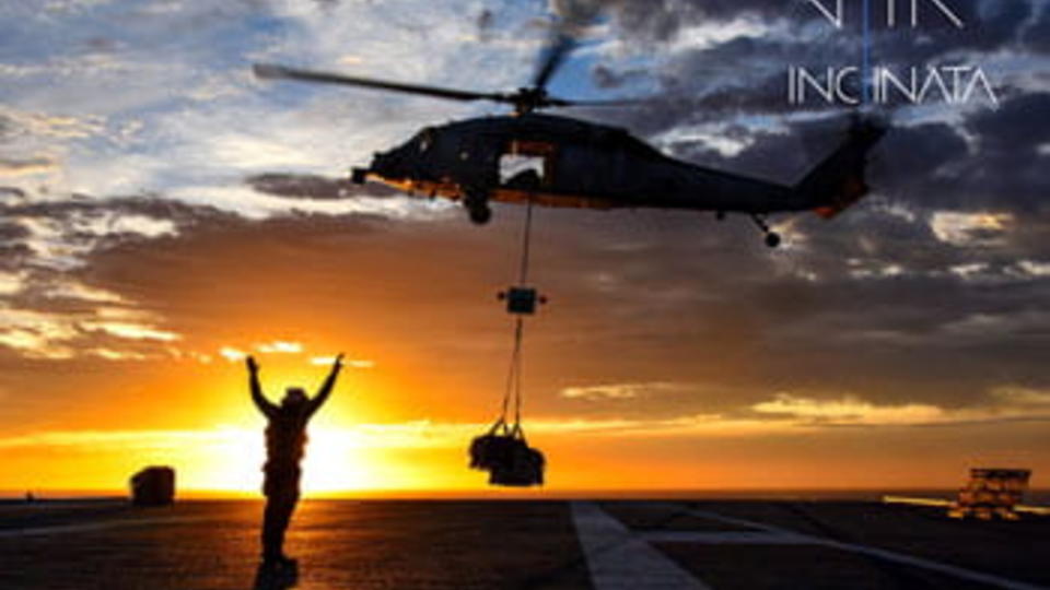 Sunrise with person waving up to helicopter 
