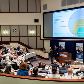 Person speak to group in an auditorium 